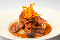 Black Pepper Sausages - grilled , mash potato, hickory smoked bacon, caramelized onions & green pepper sauce.
